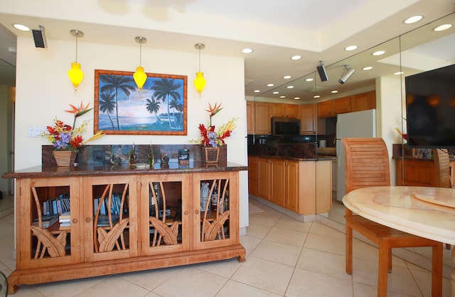 kitchen with backsplash, kitchen peninsula, hanging light fixtures, and light tile patterned floors