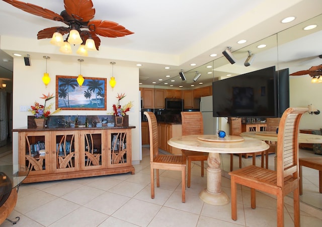 tiled dining area featuring ceiling fan