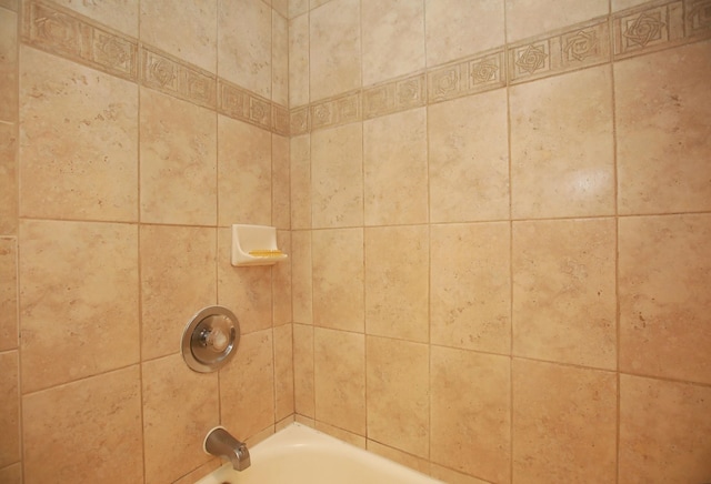 details with tiled shower / bath combo