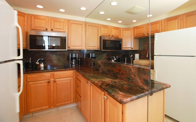 kitchen featuring light tile patterned flooring, white refrigerator, and decorative backsplash