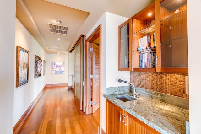 hallway with sink and light hardwood / wood-style floors