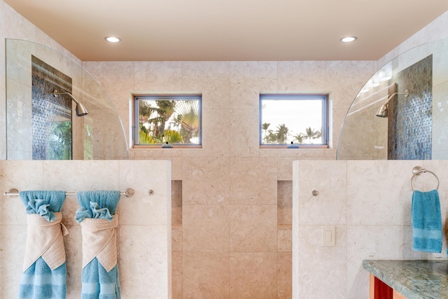 bathroom featuring vanity and tiled shower