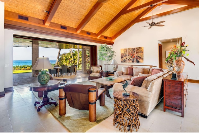 living room with a water view, high vaulted ceiling, light tile patterned floors, and beam ceiling