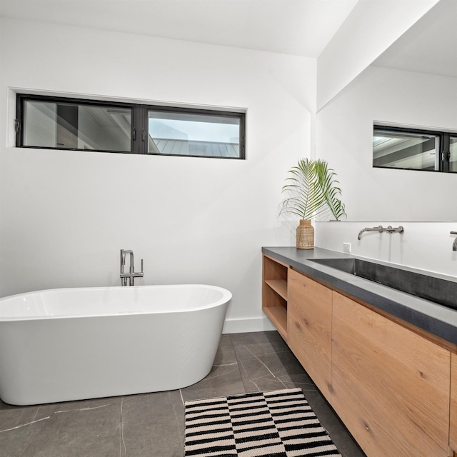 715 Laulama Pl Unit 45, Lahaina, HI 96761 - bathroom featuring vanity, a soaking tub, and baseboards