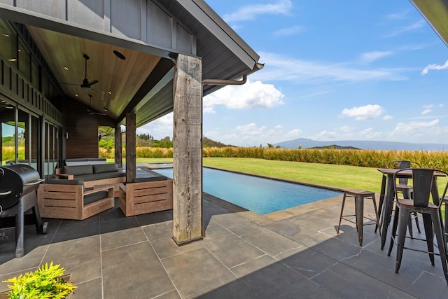715 Laulama Pl Unit 45, Lahaina, HI 96761 - view of patio / terrace with an outdoor pool, a mountain view, and a ceiling fan