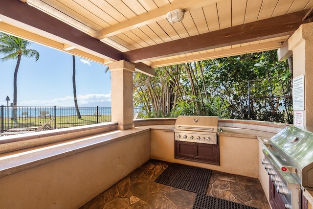 view of patio featuring grilling area, a water view, and area for grilling