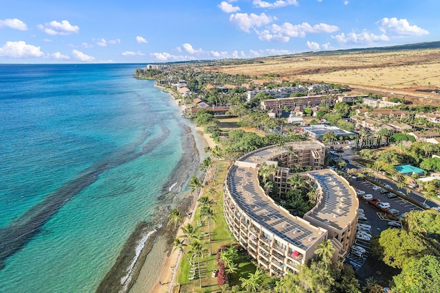 birds eye view of property with a view of the beach and a water view