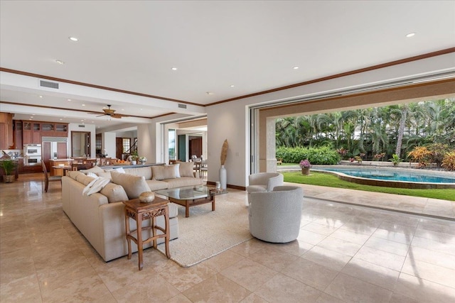 tiled living room featuring ceiling fan and ornamental molding