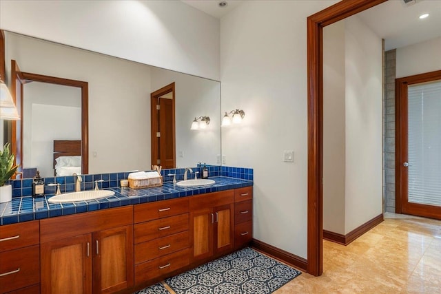 bathroom with large vanity, tile floors, and dual sinks