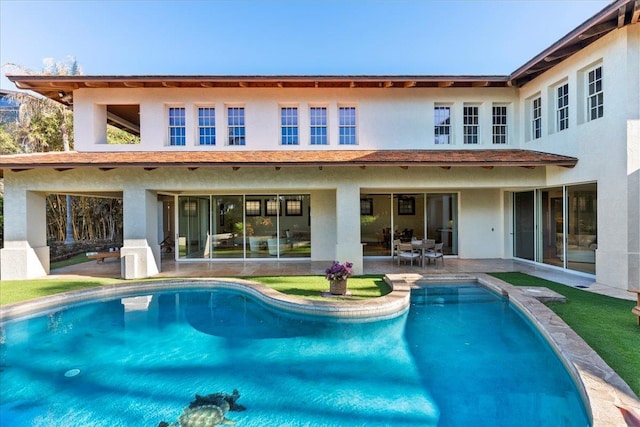 rear view of property featuring a patio