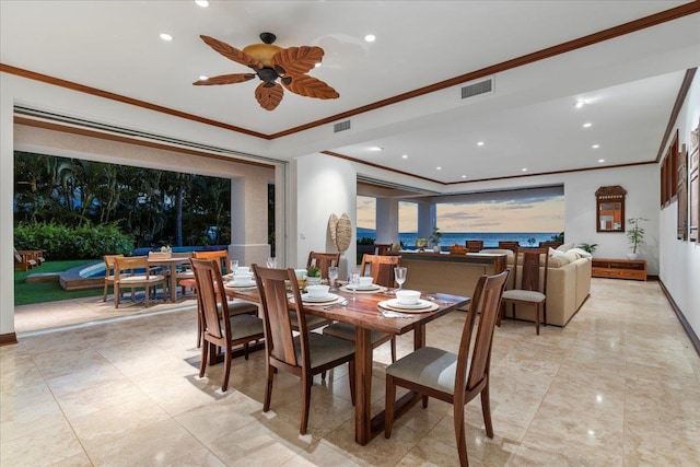 dining room with ceiling fan, ornamental molding, and light tile floors