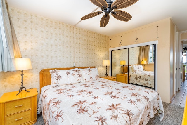 bedroom featuring tile patterned flooring, a closet, and ceiling fan