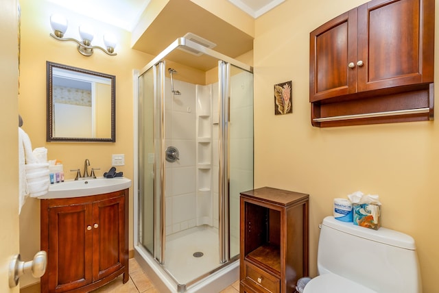 bathroom with tile patterned flooring, vanity, toilet, and an enclosed shower