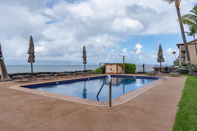 view of pool featuring a water view