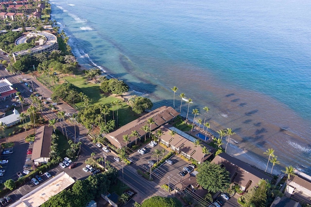 drone / aerial view with a water view and a beach view