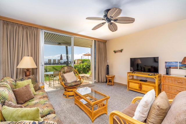 carpeted living room with ceiling fan