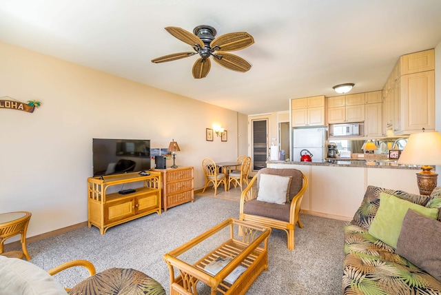 living room featuring light carpet and ceiling fan