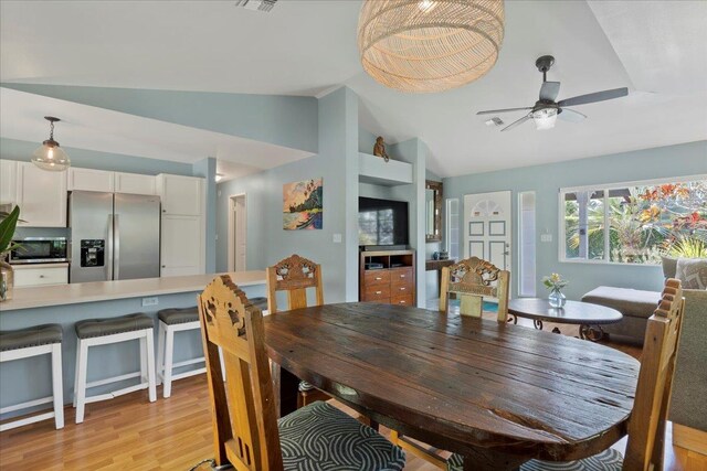 kitchen featuring appliances with stainless steel finishes, white cabinets, hanging light fixtures, and sink