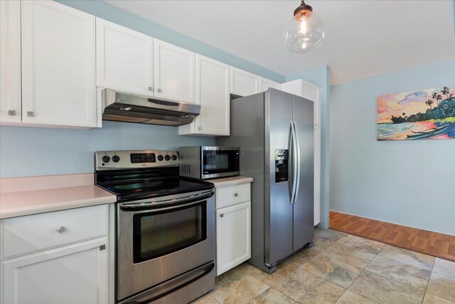 kitchen featuring pendant lighting, stainless steel appliances, and white cabinetry