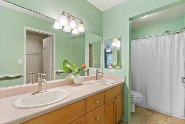 bathroom featuring toilet, vanity, a shower with curtain, and a chandelier