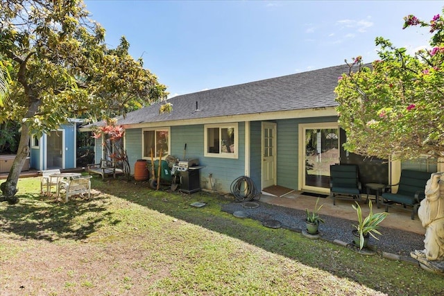 back of house with a lawn