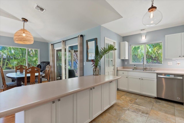 kitchen with decorative light fixtures, white cabinets, stainless steel dishwasher, and sink