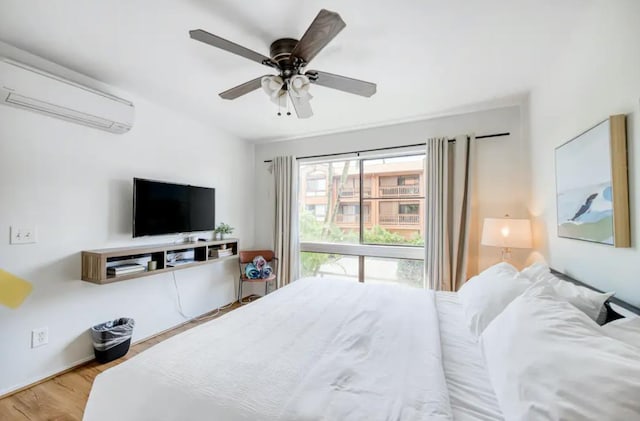 3740 Lower Honoapiilani Rd Unit B103, Lahaina, HI 96761 - bedroom featuring wood finished floors, a wall mounted air conditioner, and ceiling fan