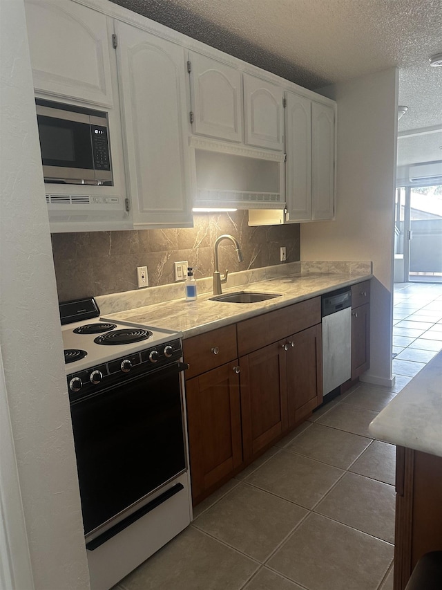 715 S Kihei Rd Unit D143, Kihei, HI 96753 - kitchen with appliances with stainless steel finishes, a sink, a textured ceiling, white cabinets, and tile patterned floors