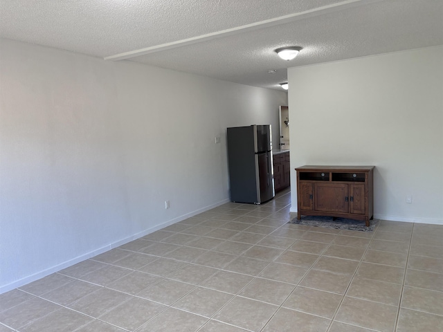 715 S Kihei Rd Unit D143, Kihei, HI 96753 - empty room featuring a textured ceiling, light tile patterned floors, and baseboards