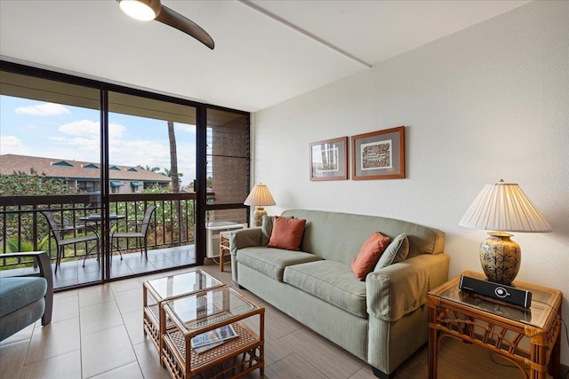 tiled living room featuring floor to ceiling windows and ceiling fan