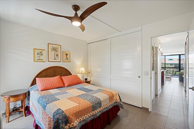 bedroom with a closet, floor to ceiling windows, and ceiling fan