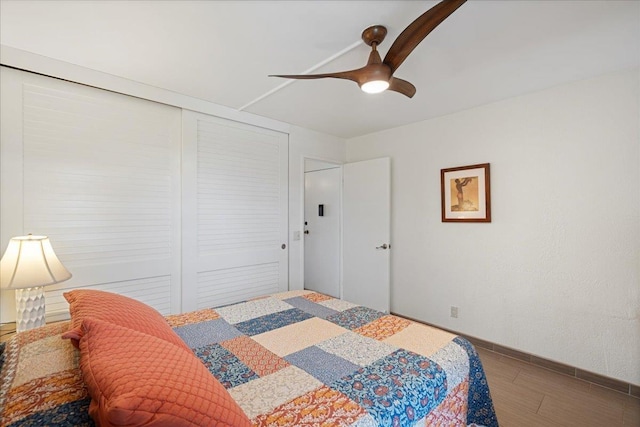 bedroom with wood finished floors, a ceiling fan, and baseboards