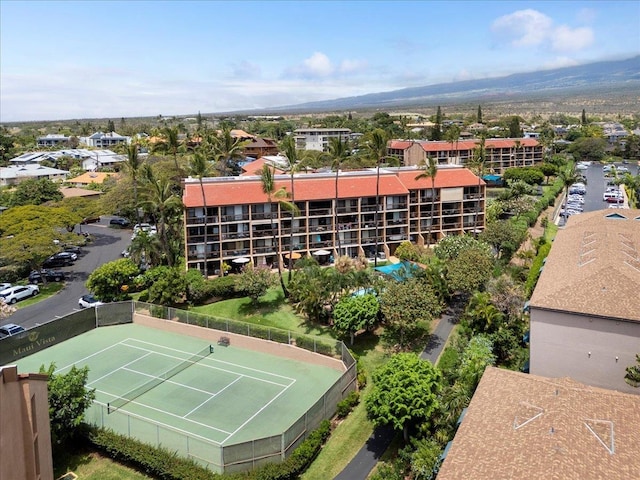 bird's eye view of apartment complex and a mountainous background