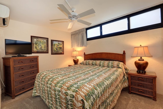 carpeted bedroom with a wall mounted air conditioner and ceiling fan
