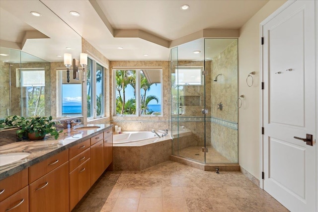 bathroom with vanity and separate shower and tub