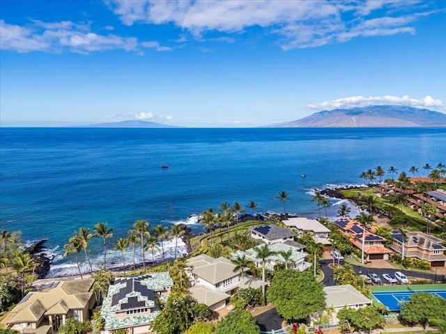 birds eye view of property with a water and mountain view