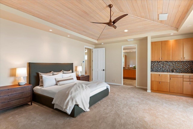 bedroom featuring light carpet, a tray ceiling, ceiling fan, and wood ceiling