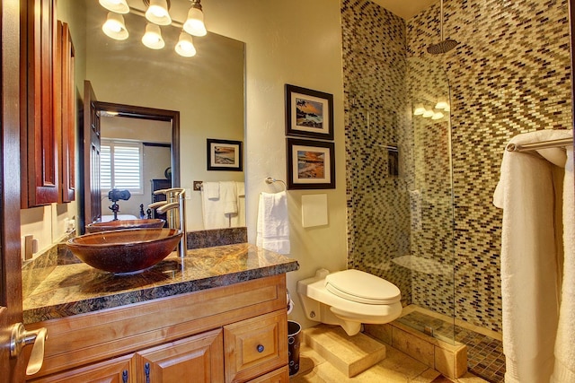 bathroom with toilet, tile patterned flooring, vanity, and walk in shower