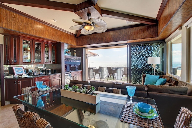 interior space featuring ceiling fan, beverage cooler, wood walls, light tile patterned flooring, and ornamental molding