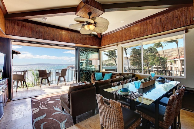 sunroom / solarium with ceiling fan and lofted ceiling with beams