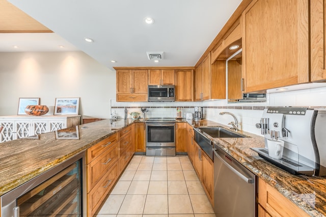 kitchen with dark stone counters, wine cooler, stainless steel appliances, and light tile patterned flooring