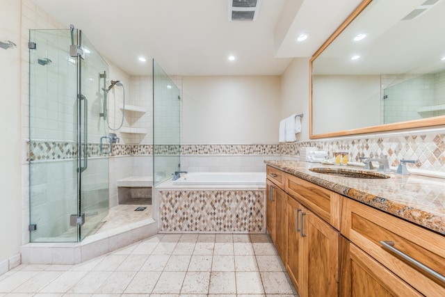 bathroom with backsplash, separate shower and tub, tile patterned floors, and vanity