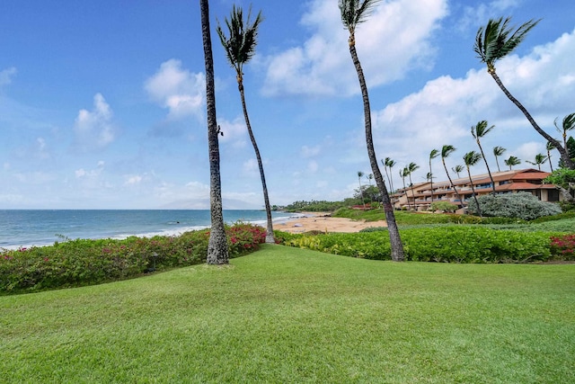 view of community with a lawn and a water view