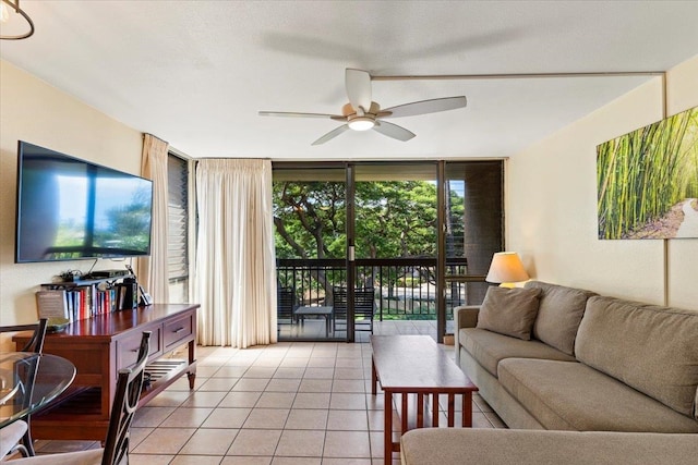 tiled living room with ceiling fan and expansive windows