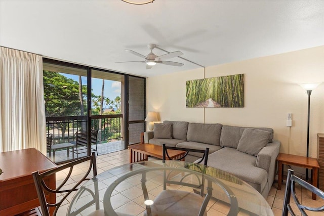 living room with expansive windows, light tile patterned floors, and ceiling fan