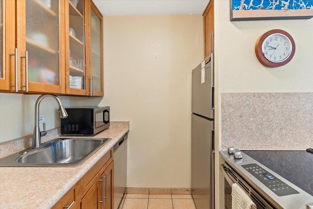 kitchen featuring sink, light tile patterned flooring, and stainless steel appliances