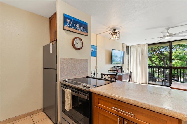 kitchen featuring ceiling fan, appliances with stainless steel finishes, and light tile patterned flooring