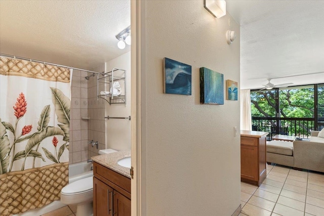 full bathroom featuring tile patterned floors, toilet, shower / tub combo, vanity, and ceiling fan