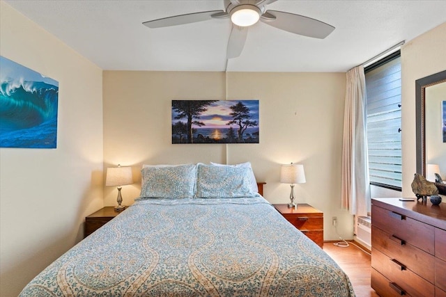 bedroom featuring light wood-type flooring and ceiling fan