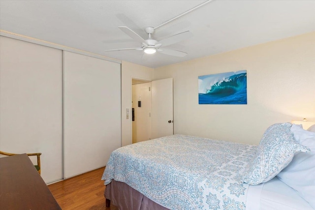 bedroom featuring a closet, wood-type flooring, and ceiling fan